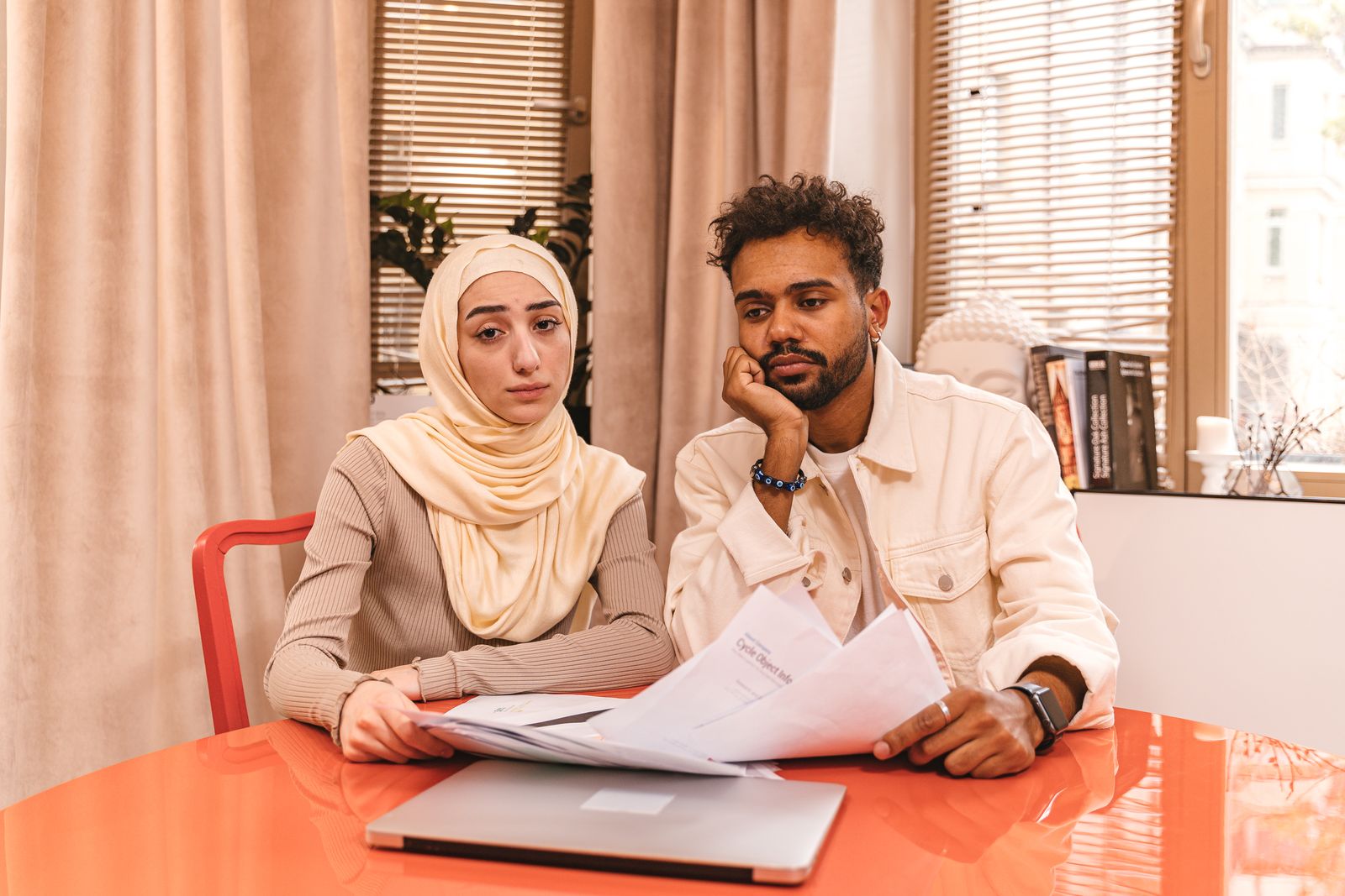 A couple reviewing home improvement documents at a table